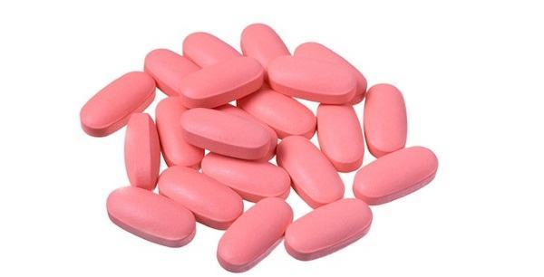 Heap of pink pills isolated